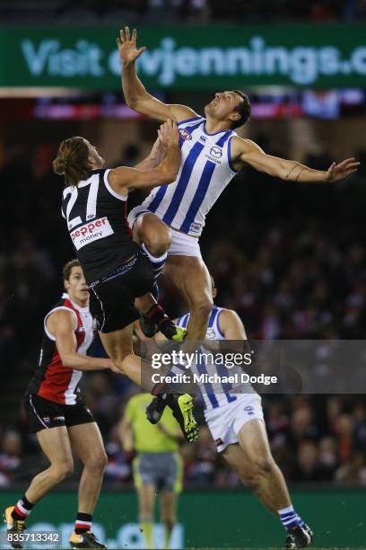 Braydon Preuss of the Kangaroos beats Josh Bruce of the Saints in the ruck contest during the round 22 AFL match between the St Kilda Saints and the...