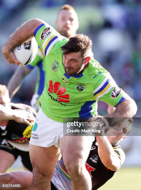 Dave Taylor of the Raiders takes on the defence during the round 24 NRL match between the Canberra Raiders and the Penrith Panthers at GIO Stadium on...