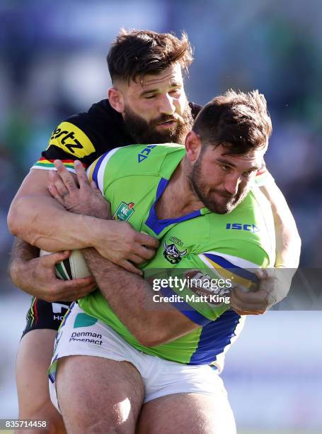 Dave Taylor of the Raiders takes on the defence during the round 24 NRL match between the Canberra Raiders and the Penrith Panthers at GIO Stadium on...