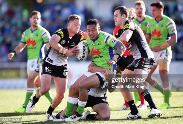 Joseph Leilua of the Raiders is tackled during the round 24 NRL match between the Canberra Raiders and the Penrith Panthers at GIO Stadium on August...