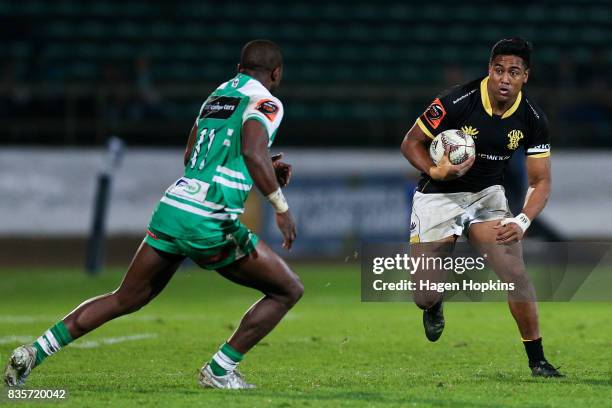 Julian Savea of Wellington looks to beat the challenge of Willy Ambaka of Manawatu during the round one Mitre 10 Cup match between Manawatu and...