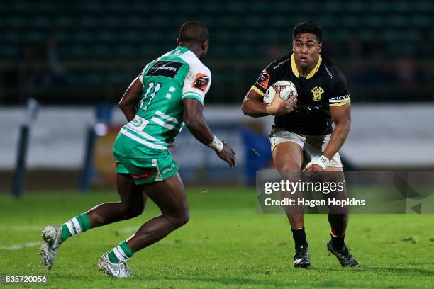 Julian Savea of Wellington looks to beat the challenge of Willy Ambaka of Manawatu during the round one Mitre 10 Cup match between Manawatu and...