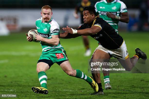 Jamie Booth of Manawatu evades the tackle of Julian Savea of Wellington during the round one Mitre 10 Cup match between Manawatu and Wellington at...