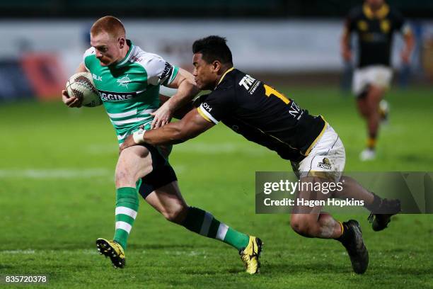 Jamie Booth of Manawatu evades the tackle of Julian Savea of Wellington during the round one Mitre 10 Cup match between Manawatu and Wellington at...