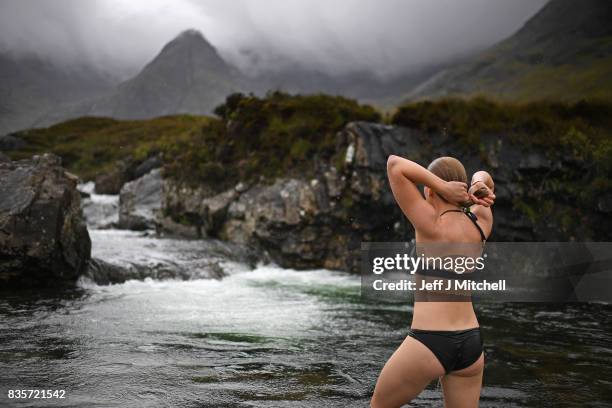 Julia Johansson from Finland swims in the Fairy Pools on the Isle of Skye on August 18, 2017 in Glenbrittle, Scotland. The Isle of Skye is known as...