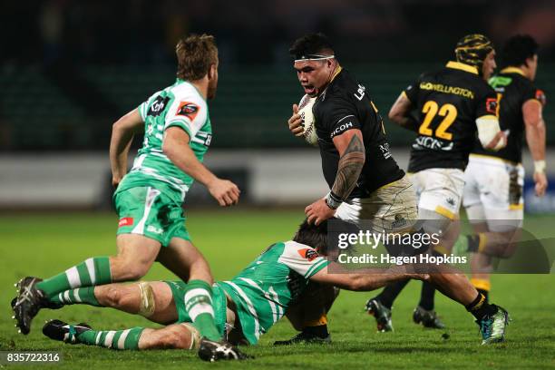 Alex Fidow of Wellington is tackled by Nick Crosswell of Manawatu during the round one Mitre 10 Cup match between Manawatu and Wellington at Central...