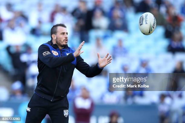 Injured Bulldogs player Josh Reynolds helps during during the warm-up before-up ahead of the round 24 NRL match between the Canterbury Bulldogs and...