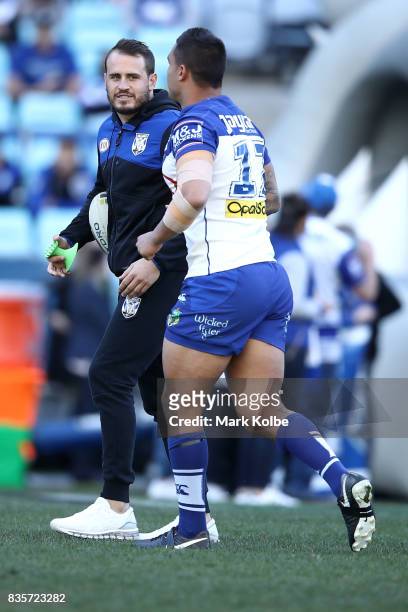 Injured Bulldogs player Josh Reynolds helps during during the warm-up before-up ahead of the round 24 NRL match between the Canterbury Bulldogs and...