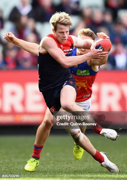 Mitch Hannan of the Demons is tackled by Alex Witherden of the Lions during the round 22 AFL match between the Melbourne Demons and the Brisbane...