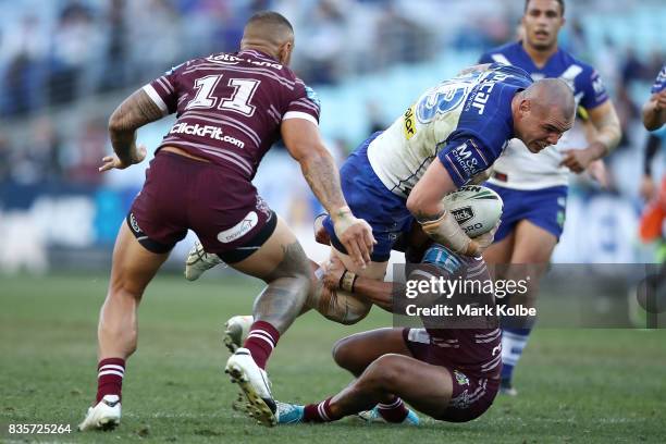 David Klemmer of the Bulldogs is tackled during the round 24 NRL match between the Canterbury Bulldogs and the Manly Sea Eagles at ANZ Stadium on...