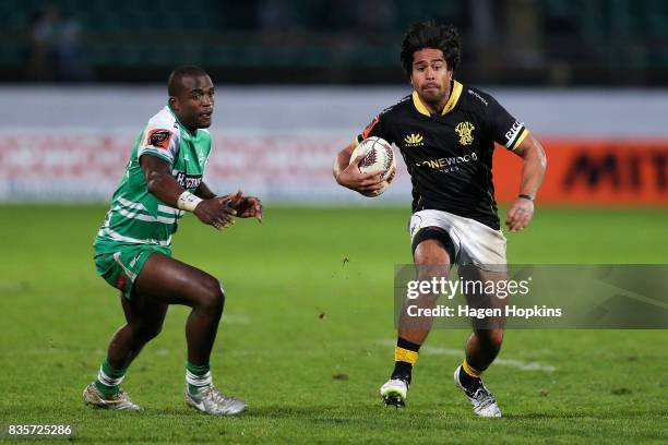 Trent Renata of Wellington beats the defence of Willy Ambaka of Manawatu during the round one Mitre 10 Cup match between Manawatu and Wellington at...