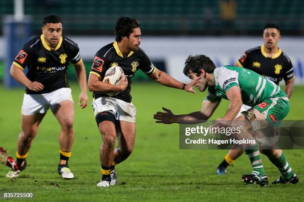 Trent Renata of Wellington fends Nick Crosswell of Manawatu during the round one Mitre 10 Cup match between Manawatu and Wellington at Central Energy...