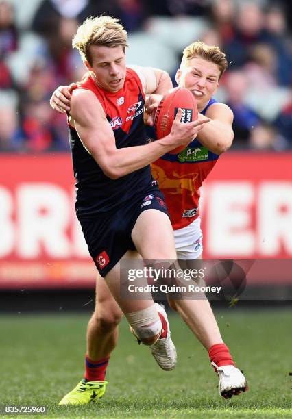 Mitch Hannan of the Demons is tackled by Alex Witherden of the Lions during the round 22 AFL match between the Melbourne Demons and the Brisbane...