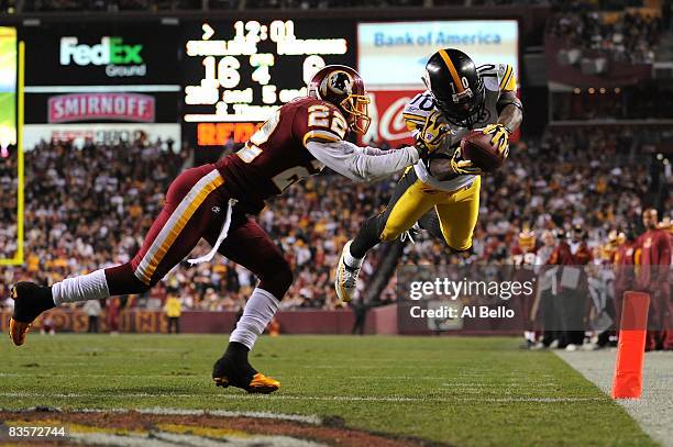 Santonio Holmes of the Pittsburgh Steelers scores a touchdown as Carlos Rogers of the Washington Redskins defends during their game on November 3,...