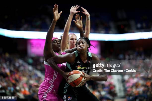 Tina Charles of the New York Liberty drives to the basket defended by defended by Lynetta Kizer of the Connecticut Sun during the Connecticut Sun Vs...