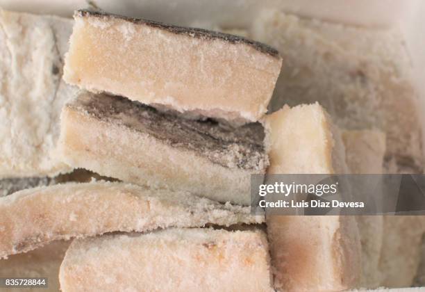 we buy one box of slices of salted cod fish - dried cod stock pictures, royalty-free photos & images
