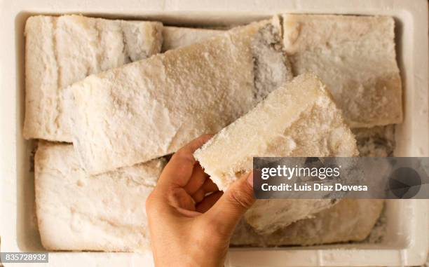 we buy one box of slices of salted cod fish - dried cod stock pictures, royalty-free photos & images