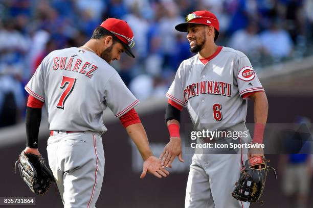 Cincinnati Reds third baseman Eugenio Suarez and Cincinnati Reds center fielder Billy Hamilton celebrate after winning against the Chicago Cubs on...