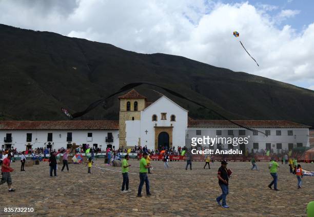People fly kites during the 42nd Wind and Kite Festival in Villa de Leyva town of Boyaca, Colombia on August 19, 2017.