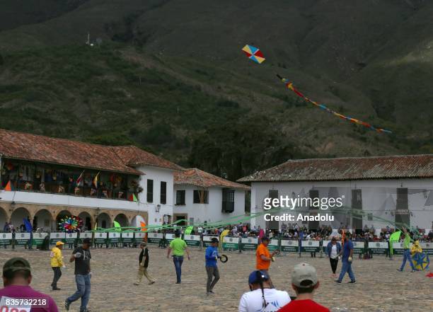 People fly kites during the 42nd Wind and Kite Festival in Villa de Leyva town of Boyaca, Colombia on August 19, 2017.