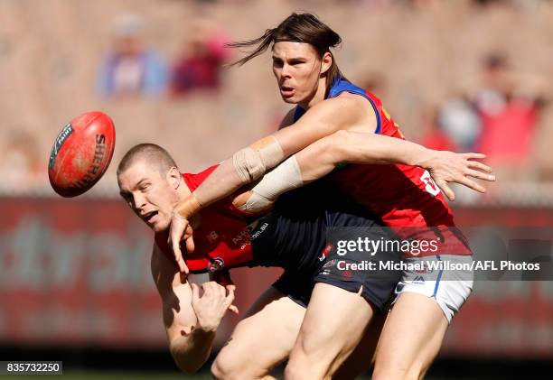 Tom McDonald of the Demons and Eric Hipwood of the Lions compete for the ball during the 2017 AFL round 22 match between the Melbourne Demons and the...