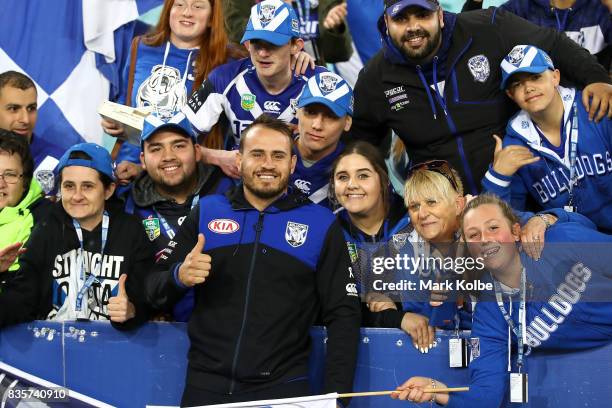 Injured Bulldogs player Josh Reynolds poses with the crowd after Bulldogs final home game of the season in the round 24 NRL match between the...