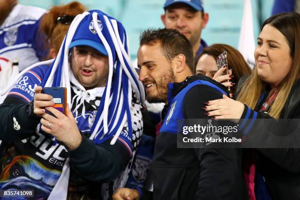 Injured Bulldogs player Josh Reynolds poses with the crowd after Bulldogs final home game of the season in the round 24 NRL match between the...