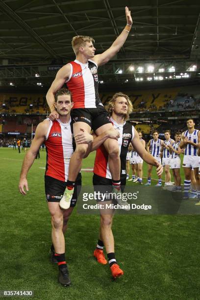 Nick Riewoldt of the Saints gets carried off by Josh Bruce and Sam Gilbert for his last home match during the round 22 AFL match between the St Kilda...