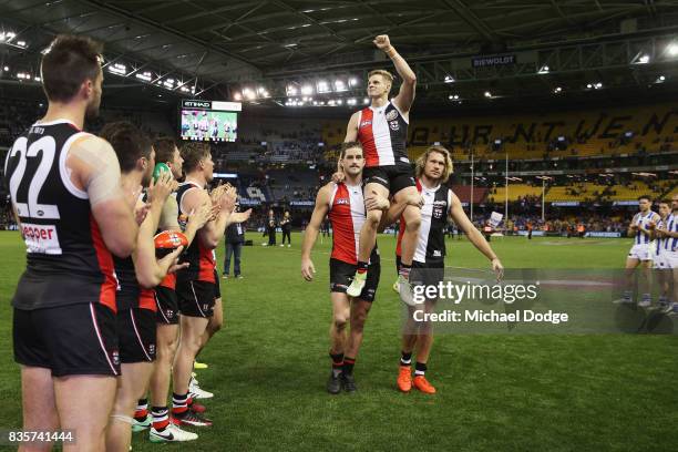 Nick Riewoldt of the Saints gets carried off by Josh Bruce and Sam Gilbert for his last home match during the round 22 AFL match between the St Kilda...