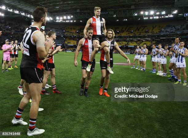 Nick Riewoldt of the Saints gets carried off by Josh Bruce and Sam Gilbert for his last home match during the round 22 AFL match between the St Kilda...