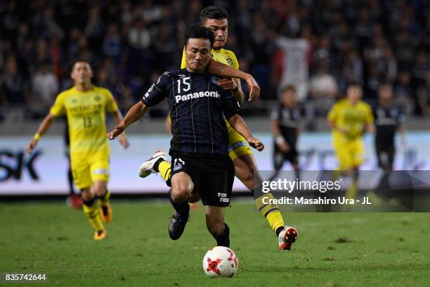 Yasuyuki Konno of Gamba Osaka and Cristiano of Kashiwa Reysol compete for the ball during the J.League J1 match between Gamba Osaka and Kashiwa...