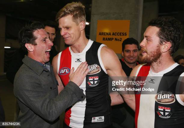 Nick Riewoldt of the Saints celebrates with former teammate Stephen Milne after winning during the round 22 AFL match between the St Kilda Saints and...