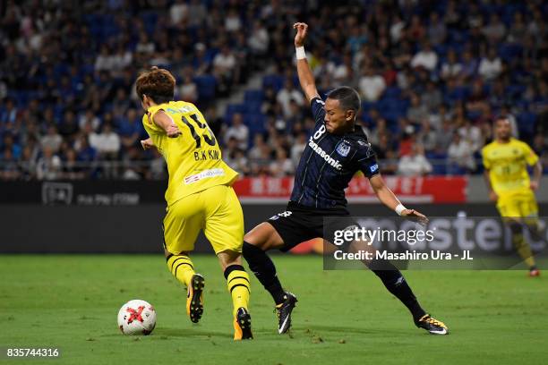 Kim Bo Kyung of Kashiwa Reysol and Yosuke Ideguchi of Gamba Osaka compete for the ball during the J.League J1 match between Gamba Osaka and Kashiwa...