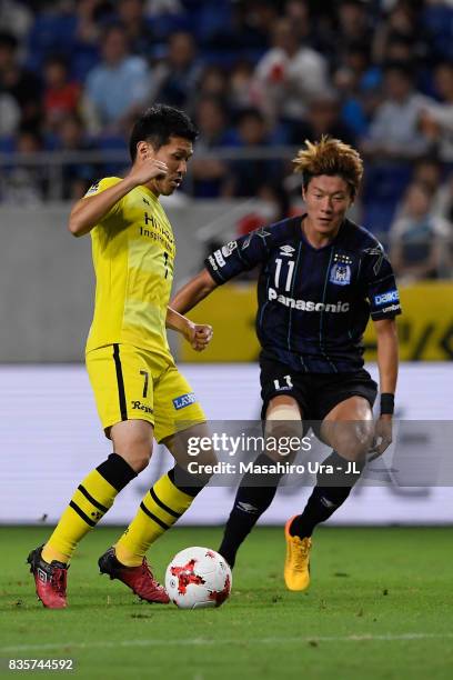 Hidekazu Otani of Kashiwa Reysol and Hwang Ui Jo of Gamba Osaka compete for the ball during the J.League J1 match between Gamba Osaka and Kashiwa...