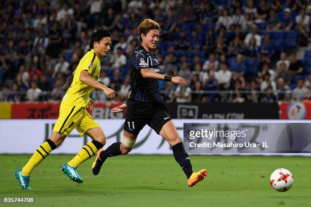 Hwang Ui Jo of Gamba Osaka and Shinnosuke Nakatani of Kashiwa Reysol compete for the ball during the J.League J1 match between Gamba Osaka and...