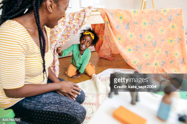 mother and daughter playing hide and seek - toddler imagination stock pictures, royalty-free photos & images