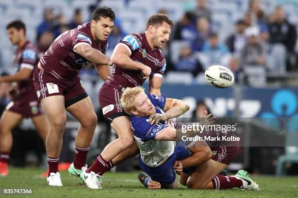 James Graham of the Bulldogs passes as he is tackled during the round 24 NRL match between the Canterbury Bulldogs and the Manly Sea Eagles at ANZ...