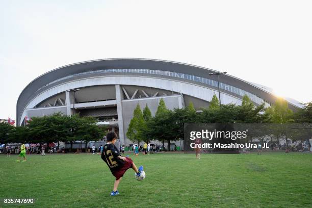 Vissel Kobe supporters play football outside the stadium prior to the J.League match between Vissel Kobe and Yokohama F.Marinos at Noevir Stadium...