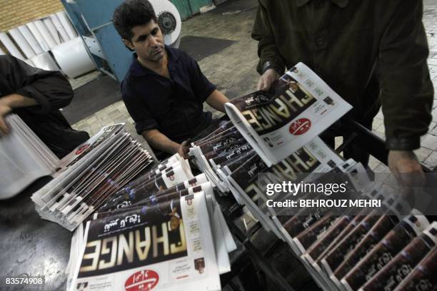 An Iranian printing technician checks printed copies of Iranian reformist daily "Etemad-e Melli" with a picture of US President-elect Barack Obama on...