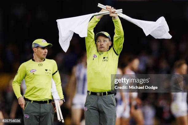 Goal umpires confirm the correct score during the round 22 AFL match between the St Kilda Saints and the North Melbourne Kangaroos at Etihad Stadium...