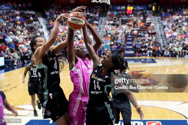 Nayo Raincock-Ekunwe of the New York Liberty, Jonquel Jones of the Connecticut Sun and Sugar Rodgers of the New York Liberty challenge for a rebound...