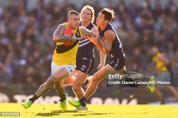Dustin Martin of the Tigers is held up by Lachie Weller of the Dockers during the 2017 AFL round 22 match between the Fremantle Dockers and the...