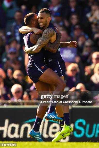 Harley Bennell and Bradley Hill of the Dockers of the Dockers celebrates a goal during the 2017 AFL round 22 match between the Fremantle Dockers and...