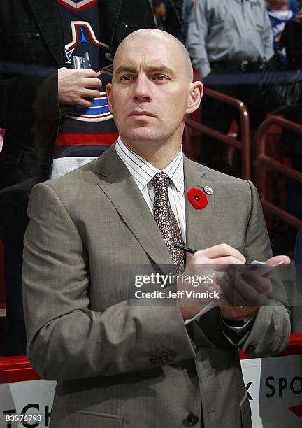 Assistant coach Darryl Williams of the Vancouver Canucks looks on from the bench during the game against the Detroit Red Wings at General Motors...