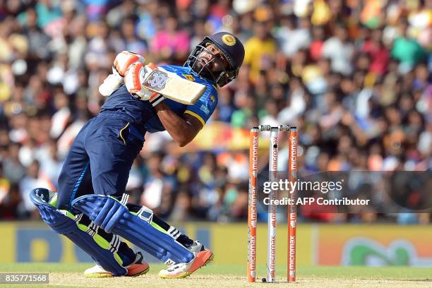 Sri Lankan cricketer Niroshan Dickwella tries to avoid a bouncer of Indian cricketer Hardik Pandya during the first One Day International cricket...