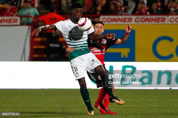 Djaniny Tavares of Santos Laguna and Damian Perez of Tijuana compete for the ball during the fifth round match between Tijuana and Santos Laguna as...