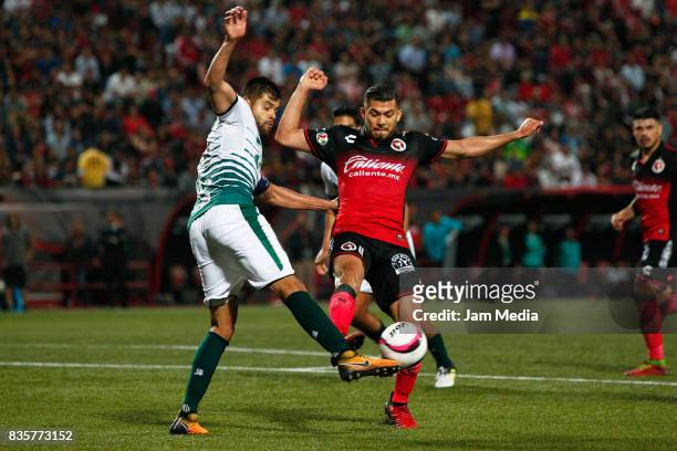 Nestor Araujo of Santos Laguna and Henry Martin of Tijuana compete for the ball during the fifth round match between Tijuana and Santos Laguna as...