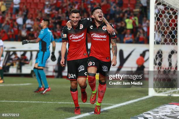 Gustavo Bou of Tijuana celebrates with Luis Chavez after scoring the opening goal for his team during the fifth round match between Tijuana and...