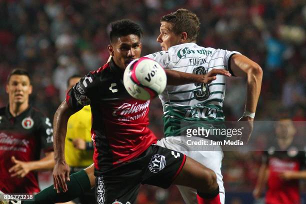 Juan Valenzuela of Tijuana and Julio Furch of Santos Laguna compete for the ball during the fifth round match between Tijuana and Santos Laguna as...