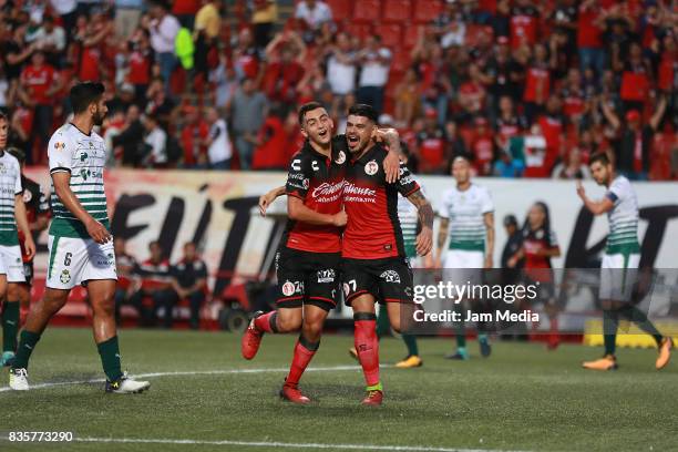 Gustavo Bou of Tijuana celebrates with Luis Chavez after scoring the opening goal for his team during the fifth round match between Tijuana and...